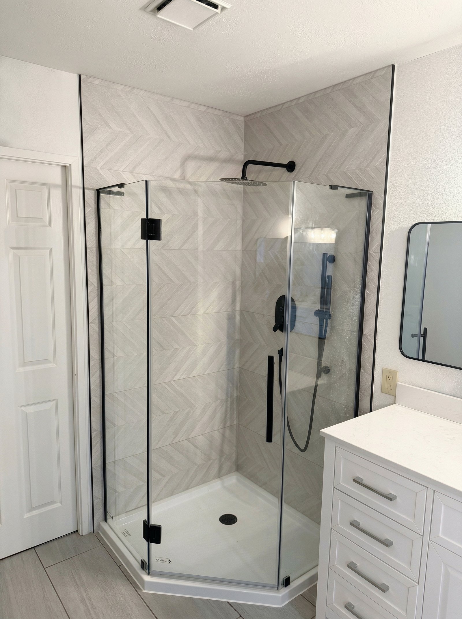 Bathroom remodel featuring a vanity, tile finishes and updated fixtures, showcasing our remodeling services in Portland, OR
